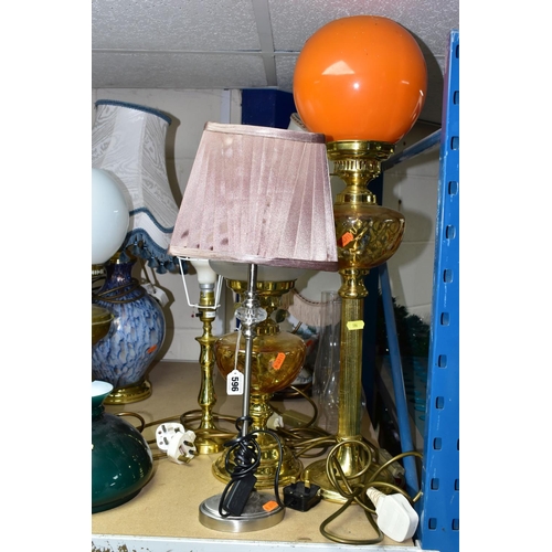 596 - EIGHT TABLE LAMPS, SHADES AND CHIMNEYS, comprising a brass based oil lamp, three electric lamps in t... 