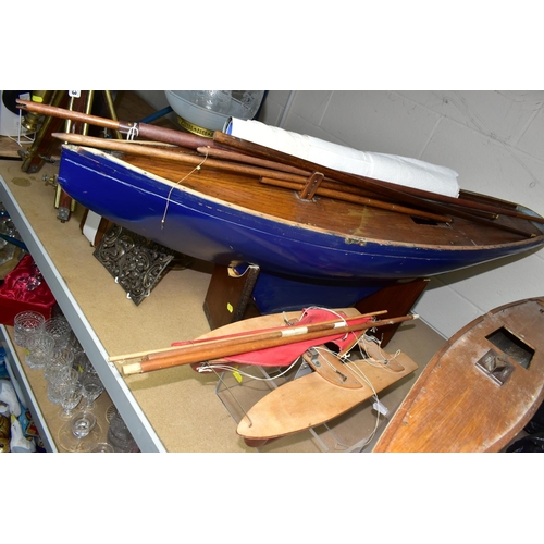 631 - A GROUP OF FOUR MODEL SAILING BOATS, comprising a large blue sailing yacht with mast and white sails... 