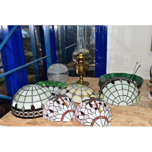 653 - A GROUP OF GLASS LIGHTSHADES, LIGHT FITTINGS AND AN OIL LAMP, comprising three leaded glass ceiling ... 