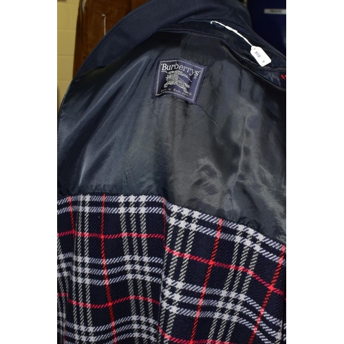 668 - A GENTLEMAN'S  CLASSIC BURBERRY RAINCOAT, in navy blue, signature check lining with a detachable 100... 