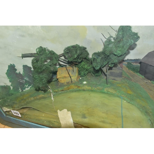 743 - TWO MID 20TH CENTURY WOOD AND GLASS CASED DIORAMAS, one containing a model of a house with several o... 