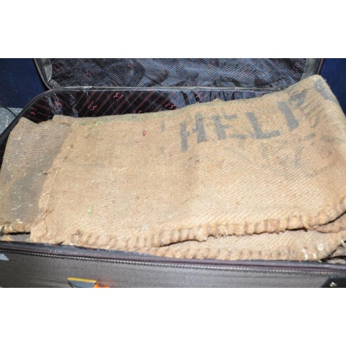 1069 - A SUITCASE CONTAINING A QUANTITY OF VINTAGE HESSIAN SACKS (14in all)