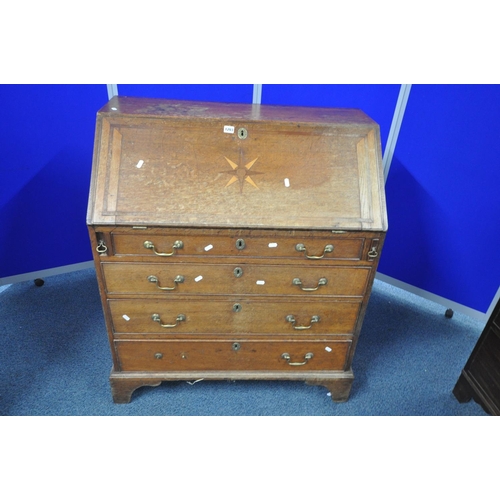 1203 - A GEORGIAN OAK FALL FRONT BUREAU, with a fitted interior, with four long graduated drawers, on brack... 