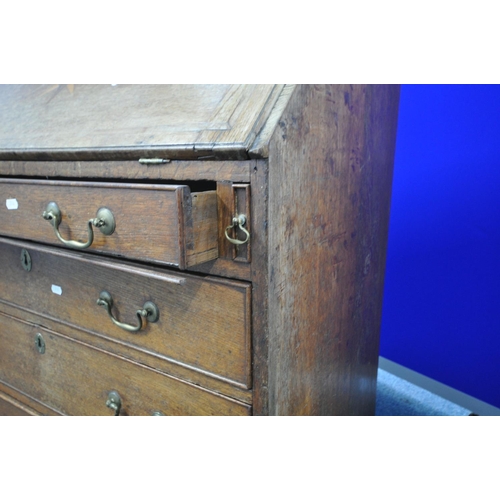 1203 - A GEORGIAN OAK FALL FRONT BUREAU, with a fitted interior, with four long graduated drawers, on brack... 