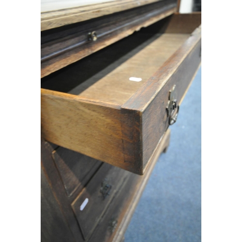 1204 - A 18TH CENTURY OAK BACHELORS CHEST OF FOUR GRADUATED DRAWERS, with a brushing slide, on bracket feet... 