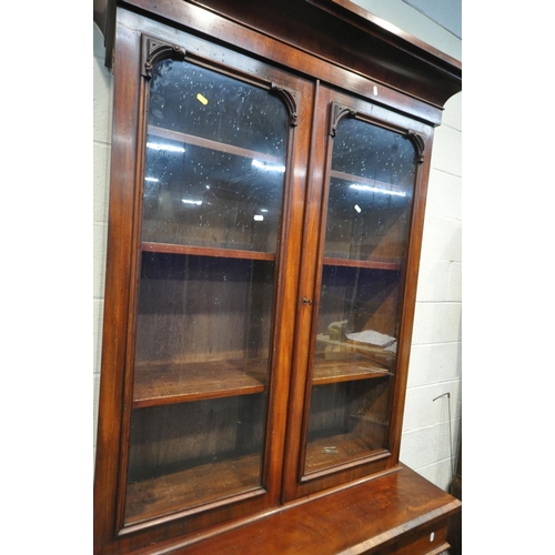 1205 - A VICTORIAN MAHOGANY BOOKCASE, with an overhanging cornice, two glazed doors, enclosing three adjust... 