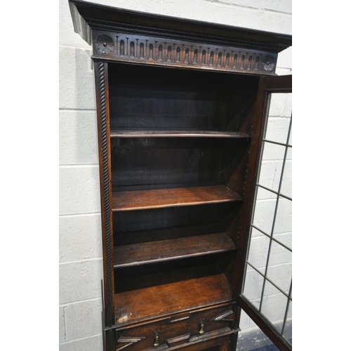 1208 - AN EARLY 20TH CENTURY OAK LEAD GLAZED SINGLE DOOR BOOKCASE, enclosing three adjustable shelves, abov... 