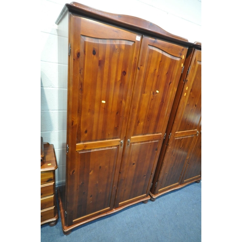 1211 - A STAINED PINE BEDROOM SUITE, comprising two double door wardrobes, width 104cm x depth 56cm x heigh... 