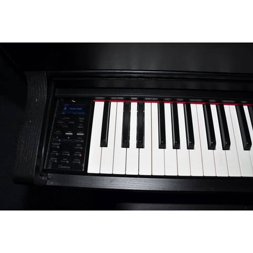 837 - A YAMAHA CLAVINOVA CLP545 DIGITAL ELECTRIC PIANO in matt black finish with manual, a matching black ... 