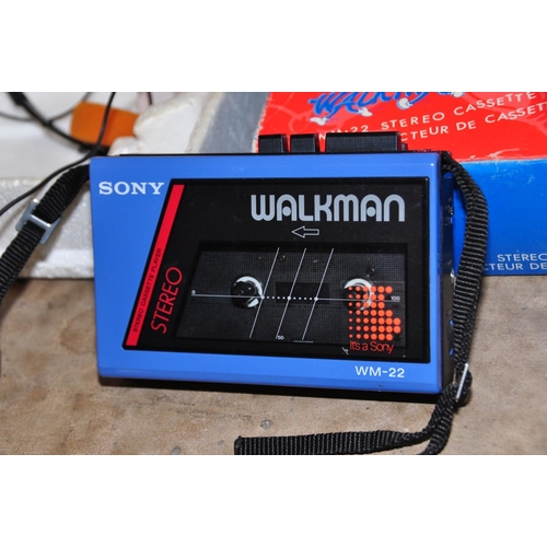 869 - A VINTAGE SONY WM-22 WALKMAN in blue and black with a pair of Min 2A headphones and original box ( i... 