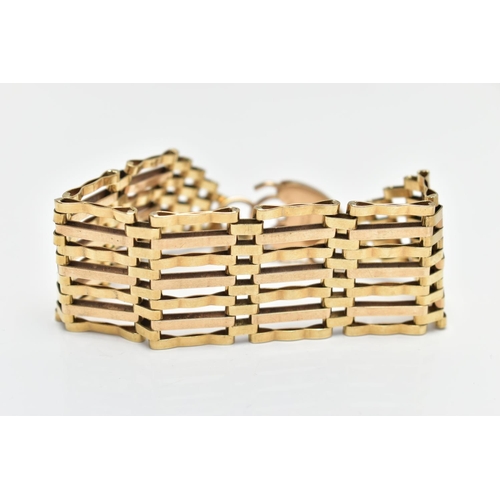 10 - A MID 20TH CENTURY 9CT YELLOW GOLD GATE BRACELET, designed as a series of plain polished and grooved... 