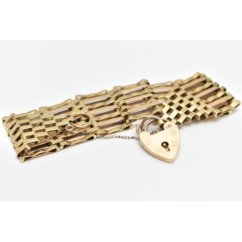 10 - A MID 20TH CENTURY 9CT YELLOW GOLD GATE BRACELET, designed as a series of plain polished and grooved... 