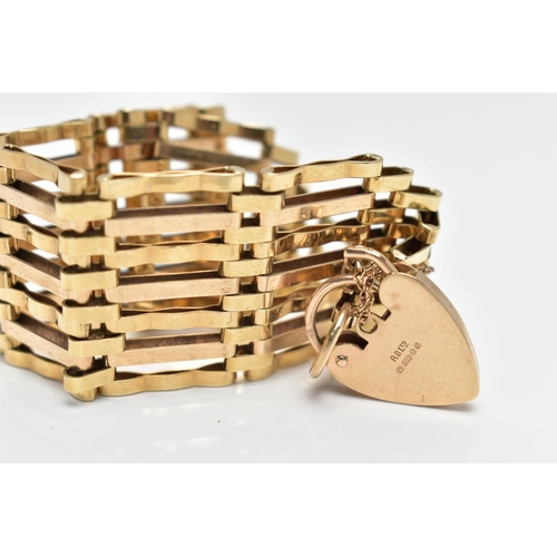 10 - A MID 20TH CENTURY 9CT YELLOW GOLD GATE BRACELET, designed as a series of plain polished and grooved... 