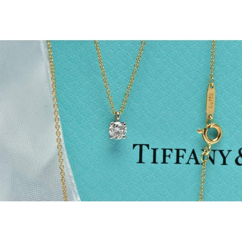 123 - AN 18CT YELLOW AND WHITE GOLD TIFFANY & CO DIAMOND PENDANT NECKLACE, set with a round brilliant cut ... 