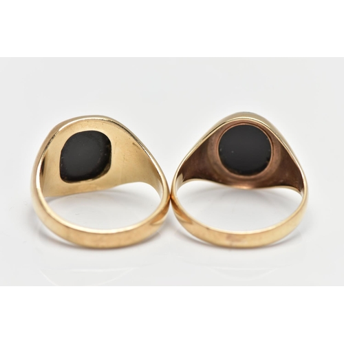 16 - TWO 9CT YELLOW GOLD ONYX SIGNET RINGS, the first set with an oval onyx panel with yellow metal inlay... 