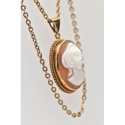 22 - A YELLOW METAL CAMEO PENDANT NECKLACE, the pendant of an oval form, set with a carved shell cameo de... 