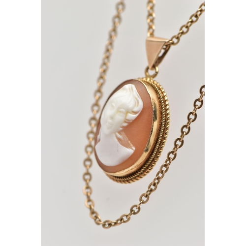 22 - A YELLOW METAL CAMEO PENDANT NECKLACE, the pendant of an oval form, set with a carved shell cameo de... 