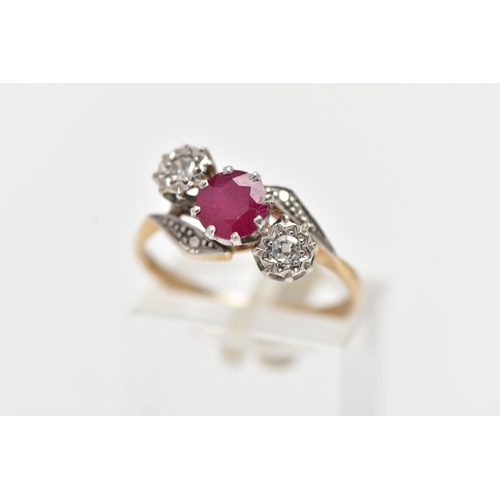 24 - A YELLOW METAL RUBY AND DIAMOND CROSSOVER RING, centering on a circular cut ruby in an eight claw se... 