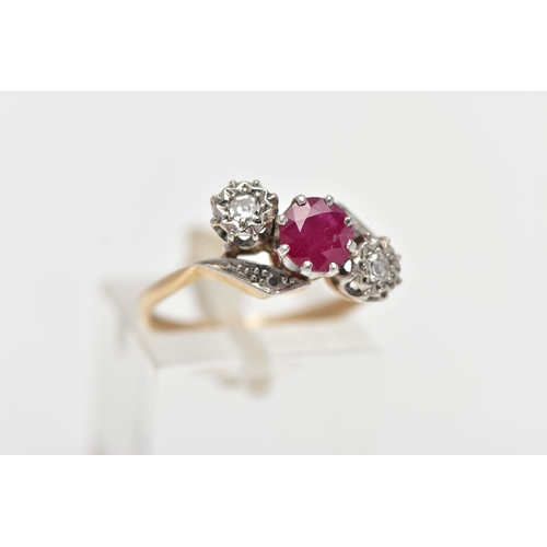 24 - A YELLOW METAL RUBY AND DIAMOND CROSSOVER RING, centering on a circular cut ruby in an eight claw se... 