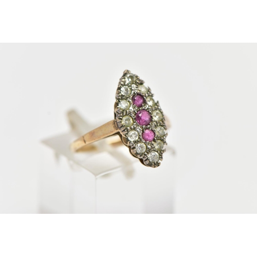 29 - A 9CT GOLD RUBY AND DIAMOND CLUSTER RING, of a navette shape, to the centre sits three circular cut ... 