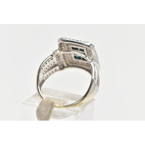 32 - A WHITE METAL DIAMOND DRESS RING, of a rectangular form, to the centre is six princess cut blue diam... 