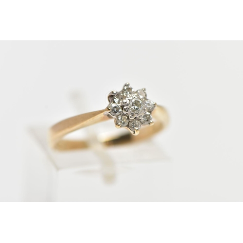 33 - A 9CT YELLOW GOLD DIAMOND CLUSTER RING, of a flower shape, set with nine round brilliant cut diamond... 