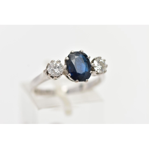 4 - AN 18CT WHITE GOLD SAPPHIRE AND DIAMOND THREE STONE RING, centering on an oval cut deep blue sapphir... 