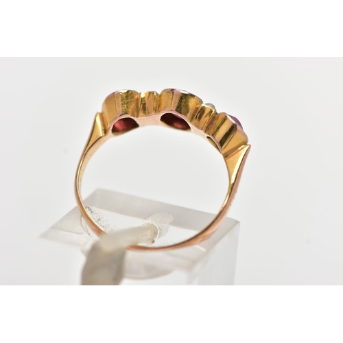 47 - AN EARLY 20TH CENTURY 9CT GOLD GEM SET RING, designed with three oval cut graduated garnets, intersp... 