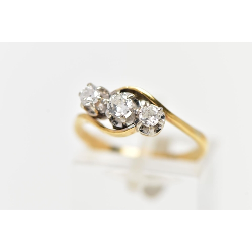 61 - A YELLOW METAL THREE STONE DIAMOND RING, three claw set, round brilliant cut diamonds, within cross ... 