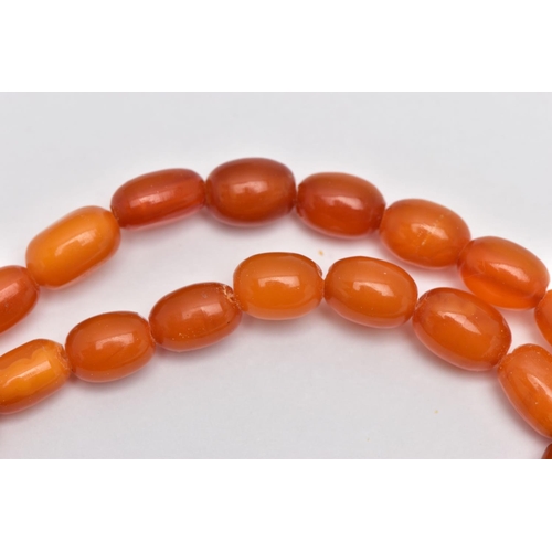 78 - A GRADUATED AMBER BEAD NECKLACE, largest oval bead measuring approximately 14.5mm, smallest measurin... 