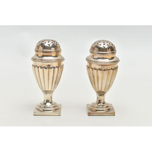 79 - A PAIR OF VICTORIAN SILVER PEPPERETTES, each of a tapering form, stop reeded design, on weighted squ... 
