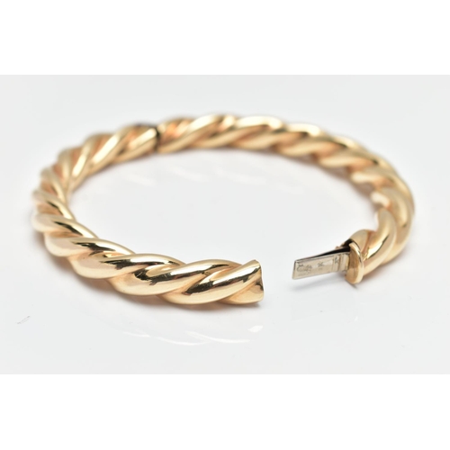 8 - A MODERN 9CT YELLOW GOLD HINGED BANGLE, designed as a plain polished twist, with concealed push piec... 