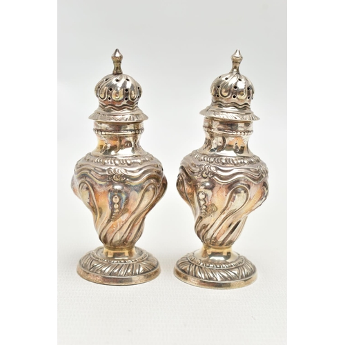 81 - A PAIR OF SILVER PEPPERETTES, each of a baluster form, embossed floral pattern, on round bases, poin... 