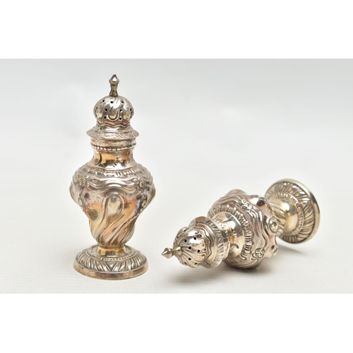 81 - A PAIR OF SILVER PEPPERETTES, each of a baluster form, embossed floral pattern, on round bases, poin... 