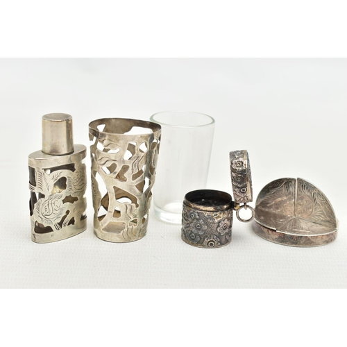 82 - FOUR WHITE METAL ITEMS, to include a glass cup with an openwork white metal floral case, hallmarked ... 