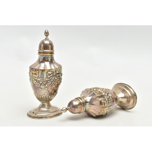84 - A PAIR OF SILVER PEPPERETTES, decorated with an embossed floral, bow and swag design, on oval bases,... 