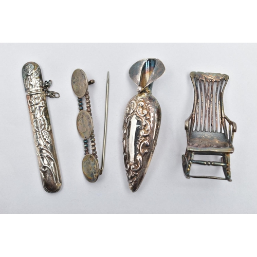 86 - FOUR WHITE METAL ITEMS, to include a brooch flower holder, with an embossed floral pattern and vacan... 
