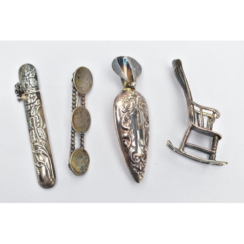 86 - FOUR WHITE METAL ITEMS, to include a brooch flower holder, with an embossed floral pattern and vacan... 