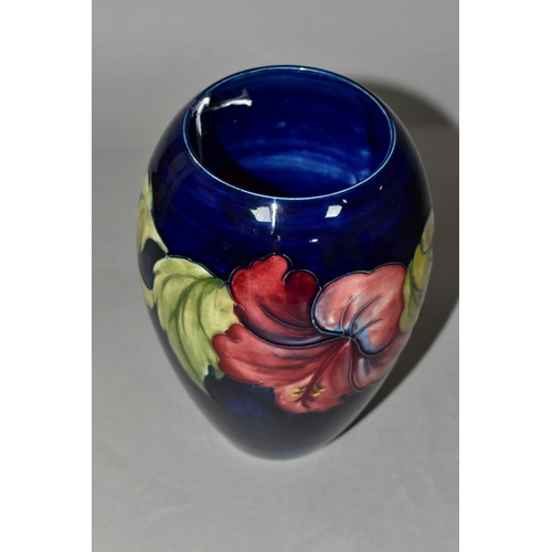 342 - A MOORCROFT POTTERY VASE, of baluster form with a mauve and yellow Hibiscus pattern on a blue ground... 
