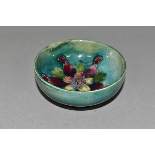 352 - A SMALL MOORCROFT POTTERY FOOTED BOWL, 'Columbine' pattern on blue/green ground, impressed marks to ... 