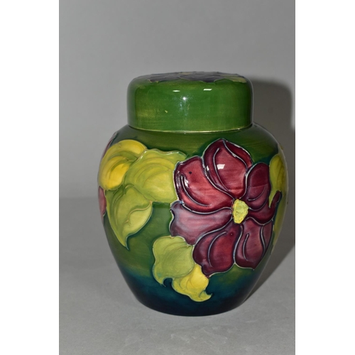 363 - A MOORCROFT POTTERY GINGER JAR AND COVER, the green ground decorated in a red/purple clematis patter... 