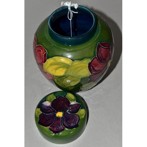 363 - A MOORCROFT POTTERY GINGER JAR AND COVER, the green ground decorated in a red/purple clematis patter... 