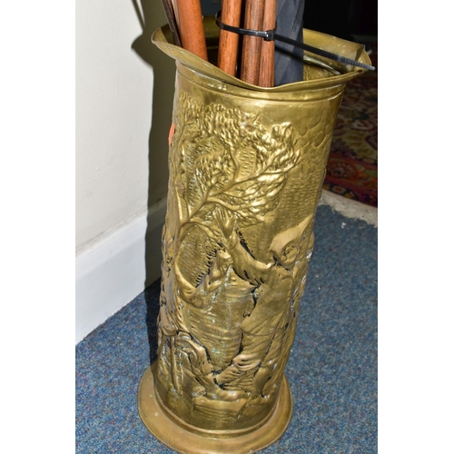 379 - A STICK STAND CONTAINING FENCING FOILS, VINTAGE GOLF CLUBS AND ICE PICKS, the brass stick stand heig... 