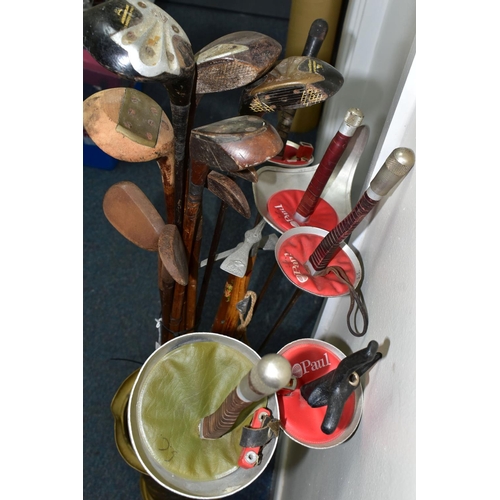 379 - A STICK STAND CONTAINING FENCING FOILS, VINTAGE GOLF CLUBS AND ICE PICKS, the brass stick stand heig... 