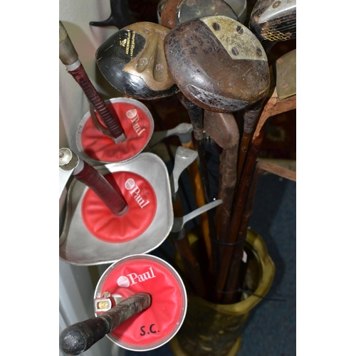 379 - A STICK STAND CONTAINING FENCING FOILS, VINTAGE GOLF CLUBS AND ICE PICKS, the brass stick stand heig... 