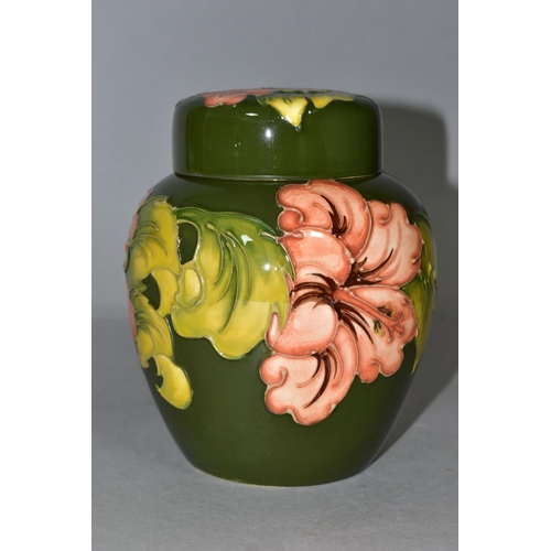 382 - A MOORCROFT POTTERY GINGER JAR AND COVER, in the Coral Hibiscus pattern on a green ground, bears pai... 