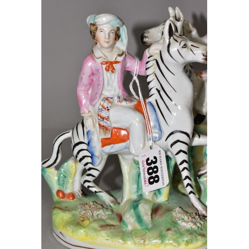 388 - A PAIR OF STAFFORDSHIRE ZEBRAS, each being ridden in a naturalistic landscape, height approximately ... 