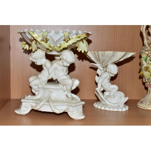 389 - SEVEN CERAMIC PIECES WITH MOULDED CHERUB DECORATION, comprising a centrepiece encrusted with flowers... 