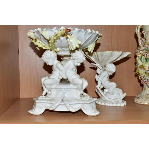 389 - SEVEN CERAMIC PIECES WITH MOULDED CHERUB DECORATION, comprising a centrepiece encrusted with flowers... 