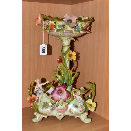 389 - SEVEN CERAMIC PIECES WITH MOULDED CHERUB DECORATION, comprising a centrepiece encrusted with flowers... 